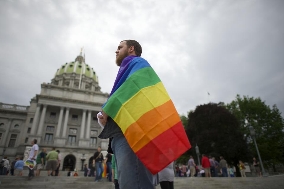 Steve Krout, 28, remains on the Pennsylvania State Capital steps following a rally with gay rights supporters after a ruling struck down a ban on same sex marriage in Harrisburg, Pennsylvania, May 20, 2014. (REUTERS/Mark Makela)