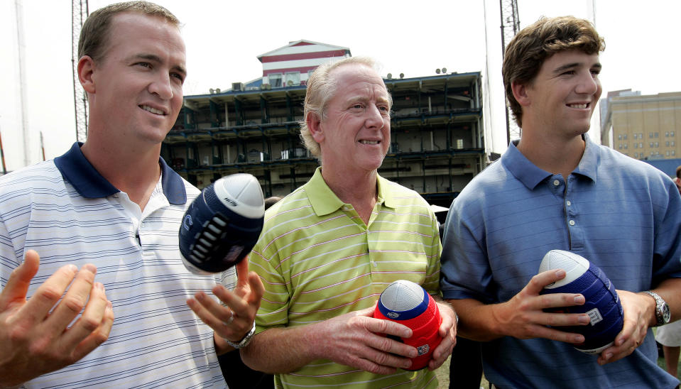 Archie Manning, center, is flanked by his NFL football quarterback sons Peyton, left, of the Indianapolis Colts, and Eli, of the New York Giants, during a Nerf Father's Day promo Saturday, June 14, 2008, in New York. Archie Manning used to play a game with his sons called "Amazing Catches," where he'd throw the ball just out of their reach and they'd have to make a diving grab. Peyton and Eli have had a lot of amazing passes lately in winning the last two Super Bowl MVP awards. (AP Photo/Stephen Chernin)