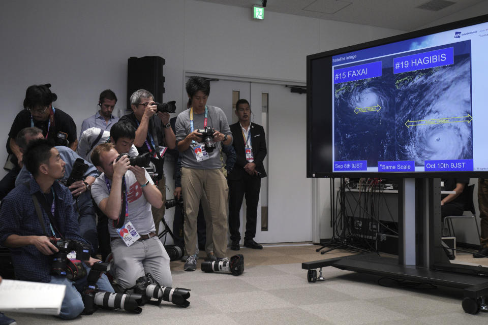 A satellite photo of typhoon Hagibis is seen during a press briefing on update relating to the anticipated impact of Typhoon Hagibis on the final round Rugby World Cup 2019 pool matches this weekend Thursday, Oct. 10, 2019, in Tokyo. (AP Photo/Eugene Hoshiko)