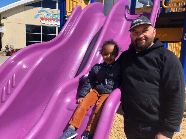 William Littlejohns and his three-year old son Tamim at Fred Thomas Park in front of Windsor Water World. (Dale Molnar/CBC - image credit)