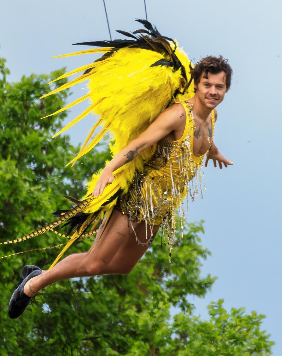 <p>Harry Styles takes flight after being shot out of a canon while performing at a local circus in the U.K. on May 10. </p>