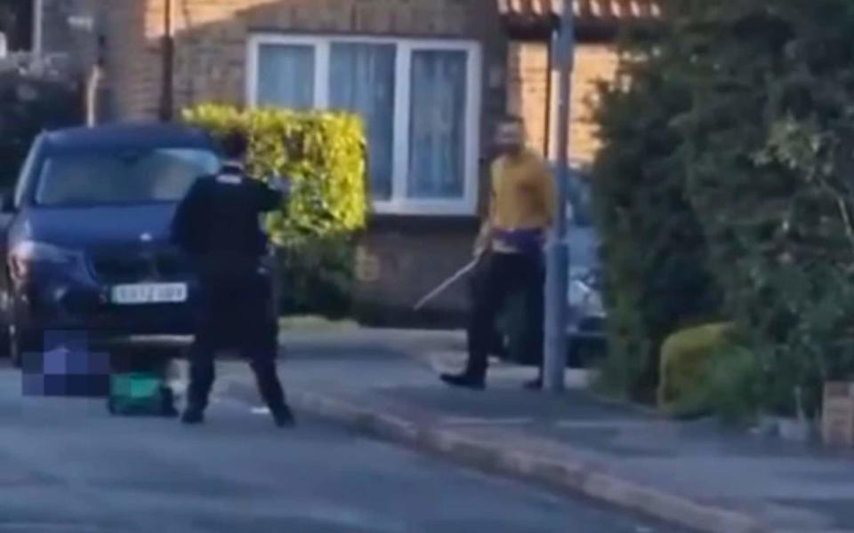 A female police officer on foot approached the man on Laing Close