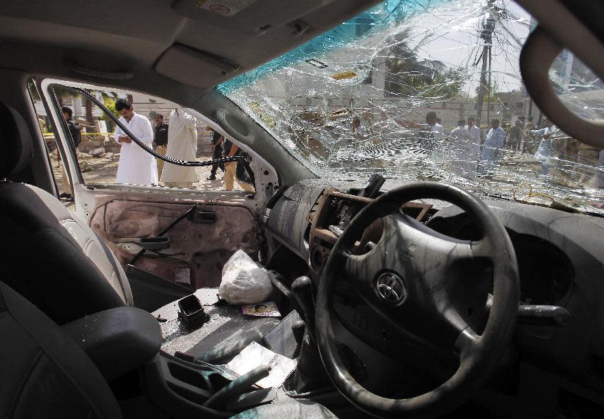 An inside view of a car damaged during a bomb blast in Karachi, Pakistan, Friday, April 25, 2014. A powerful bomb exploded Friday in an upscale residential area of southern Pakistan, killing several people and wounding others, authorities said. The attack took place in the neighborhood of Clifton in Karachi, the capital of southern Sindh province, senior police officer Abdul Khaliq Sheikh said. The bomb badly damaged several vehicles and a nearby multi-story building, he said. (AP Photo/Fareed Khan)