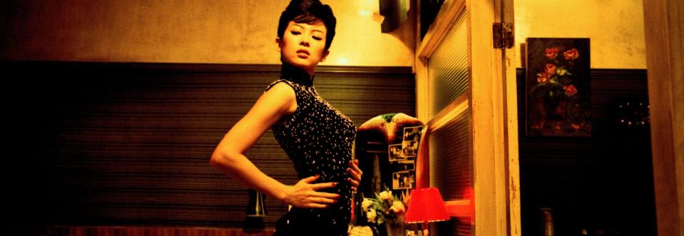 Zhang Ziyi stands in a room in an ornate dress