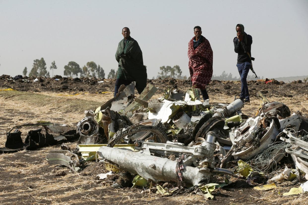 Ethiopian police officers walk past the debris of the doomed Ethiopian Airlines Boeing jet in March last year: Baz Ratner/Reuters