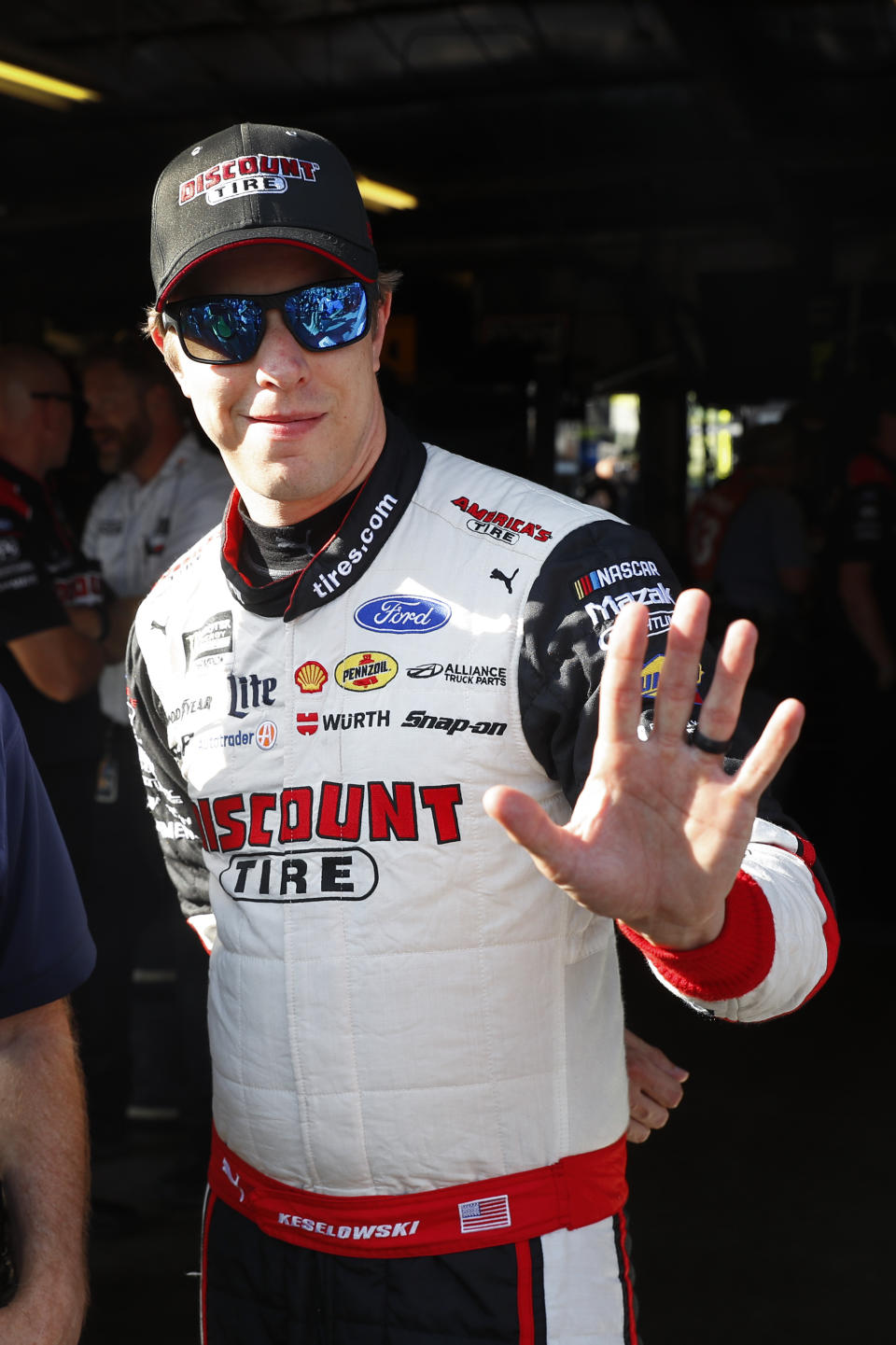 Brad Keselowski waves after winning the pole during qualifying for the NASCAR Cup Series auto race at Michigan International Speedway in Brooklyn, Mich., Friday, Aug. 9, 2019. (AP Photo/Paul Sancya)