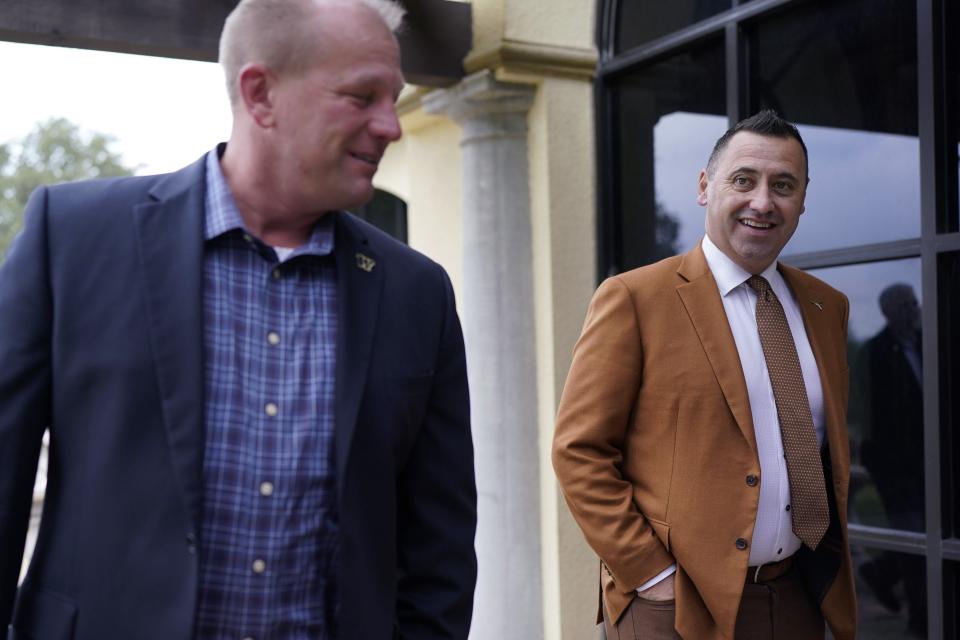 Texas  head coach Steve Sarkisian, right, and Washington's Kalen DeBoer head to a news conference for the 2022 Alamo Bowl in San Antonio. They'll meet again in Monday's Sugar Bowl, this time with a berth to the CFP championship game at stake.