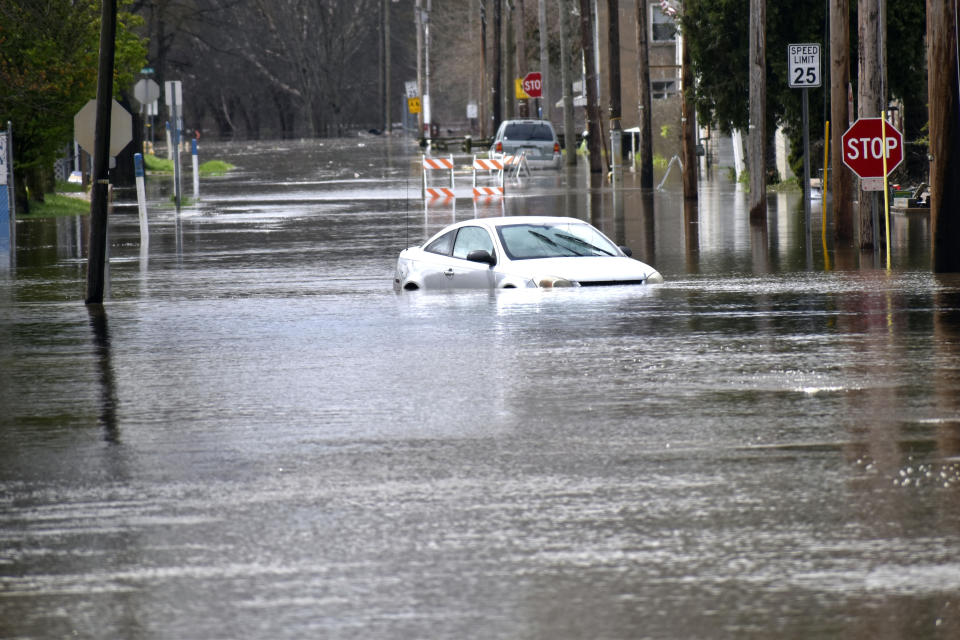 A car is floats down a street on Wheeling Island as the Ohio River floods its banks, Thursday, April 4, 2024, in Wheeling, W.Va., following days of heavy rains in the region. (Eric Ayres/The Intelligencer via AP)