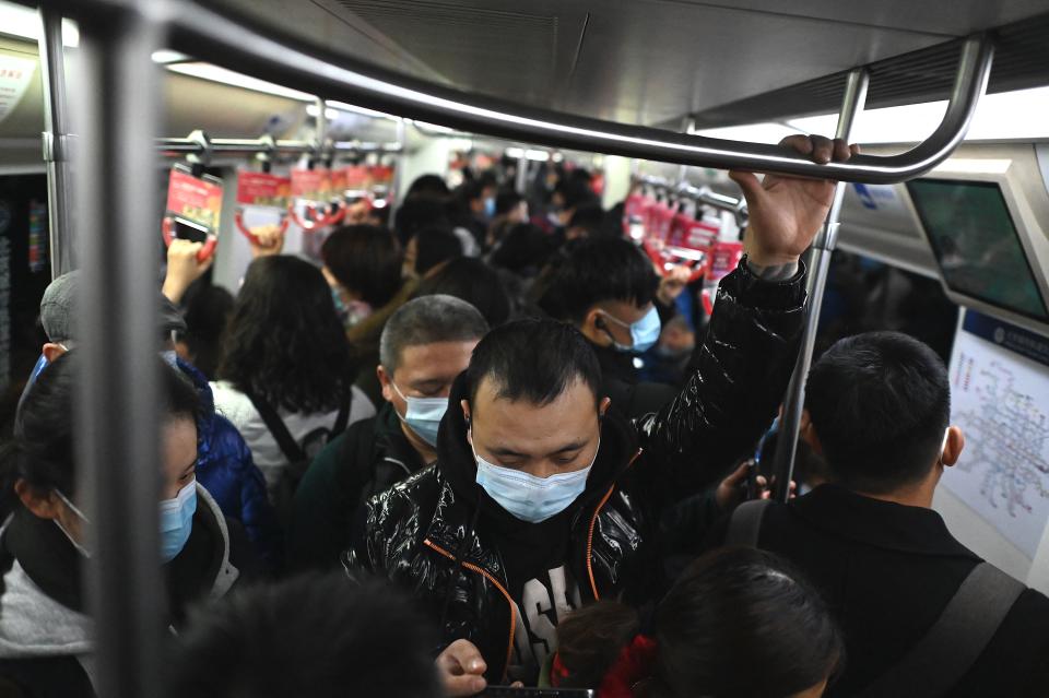 People in masks on busy subway carriage. Source: Getty Images