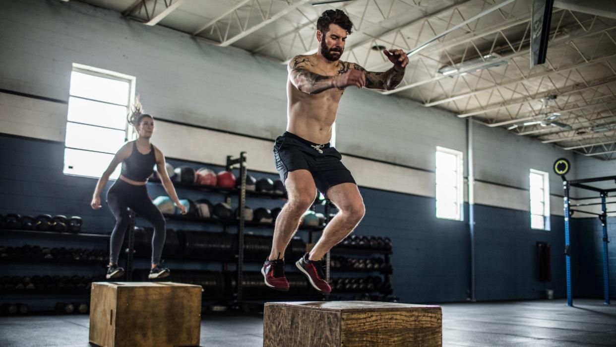  Plyometric exercise box jump being performed by a man and woman. 