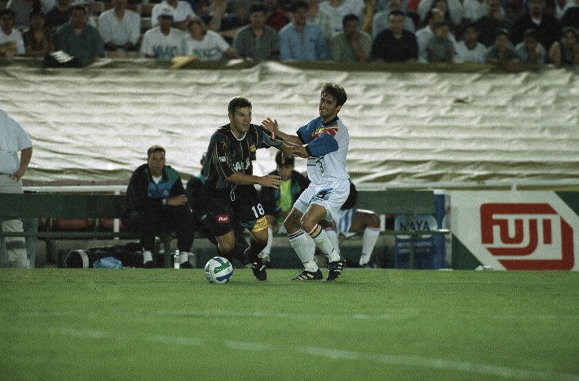 Kansas City Wizards midfielder Ryan Tinsley, right, gets pushed aside by Galaxy?s midfielder Greg Vanney at the Rose Bowl in Pasadena, Calif. on Saturday, May 31, 1997. Neither team was able to score in first period play. (AP Photo/Chris Urso)