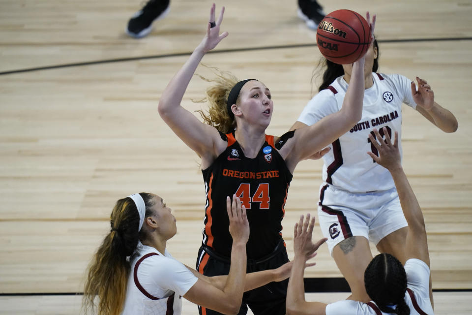 Oregon State forward Taylor Jones (44) grabs a rebound over South Carolina forward Victaria Saxton, left, during the second half of a college basketball game in the second round of the women's NCAA tournament at the Alamodome in San Antonio, Tuesday, March 23, 2021. (AP Photo/Eric Gay)