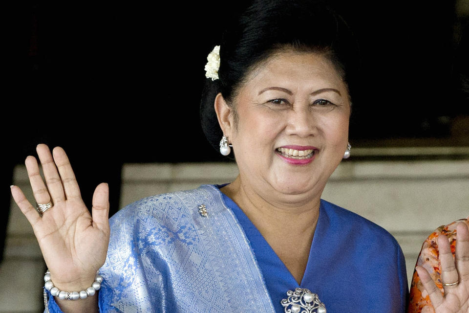 FILE - In this Oct. 20, 2014, file photo, former Indonesian first lady Kristiani Yudhoyono waves at reporters after attending an event at the parliament in Jakarta, Indonesia. Kristiani, the wife of Indonesia's sixth President Susilo Bambang Yudhoyono, has died on Saturday, June 1, 2019, in Singapore where she had been treated for cancer for several months. She was 66. (AP Photo/Mark Baker, File)