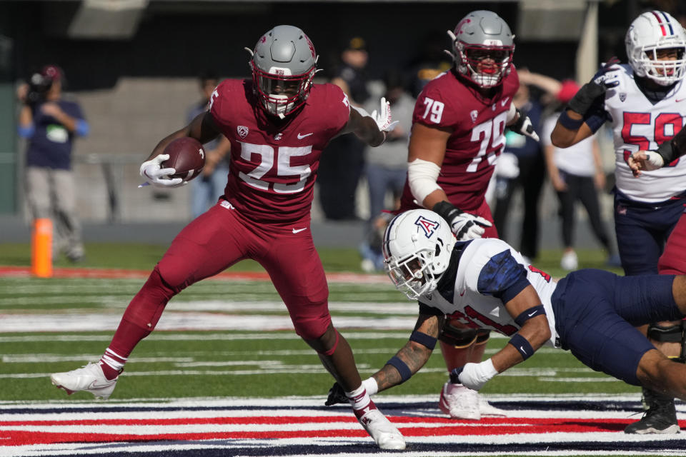 FILE - Washington State running back Nakia Watson (25) breaks away from Arizona safety Jaxen Turner in the first half during an NCAA college football game, Saturday, Nov. 19, 2022, in Tucson, Ariz. Washington State opens their season at Colorado State on Sept. 2. (AP Photo/Rick Scuteri, File)