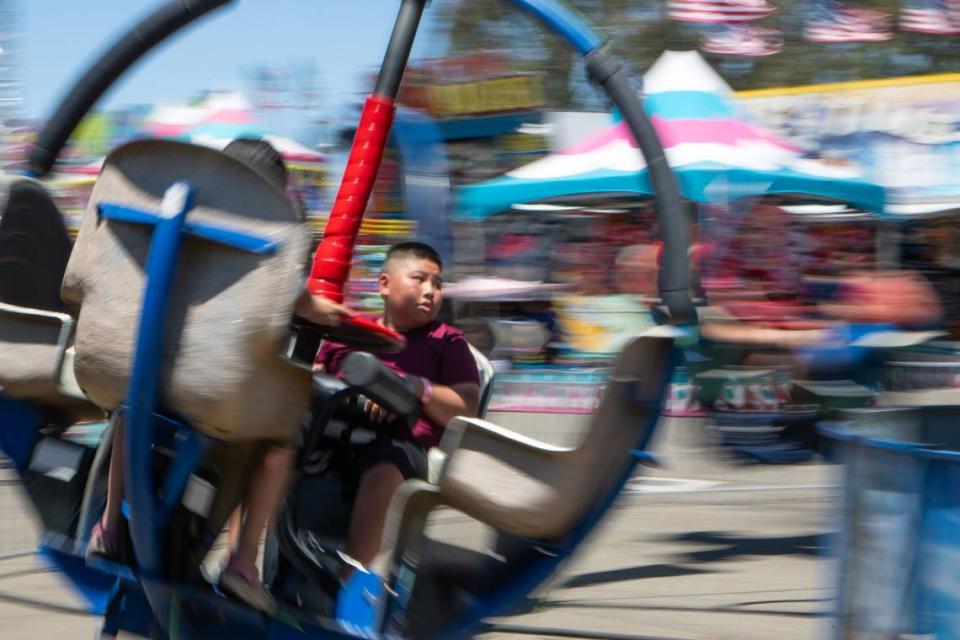Isaiah Thao, 11, twists around on the Cyclone at the California State Fair on Tuesday. Thao said he liked being spun around and didn’t feel nauseous after the ride.