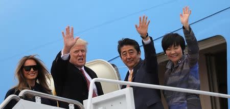 U.S. President Donald Trump and his wife Melania (L) wave with Japanese Prime Minister Shinzo Abe (2nd R) and his wife Akie Abe while boarding Air Force One as they depart for Palm Beach, Florida, at Joint Base Andrews, Maryland, U.S., February 10, 2017. REUTERS/Carlos Barria