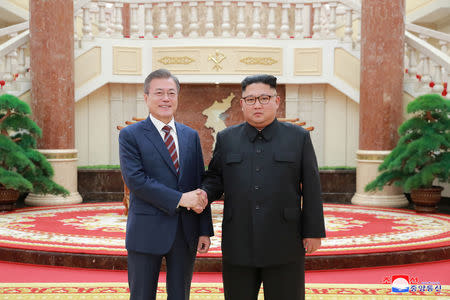 South Korean President Moon Jae-in shakes hands with North Korean leader Kim Jong Un as they arrive for their meeting at the headquarters of the Central Committee of the Workers' Party of Korea in Pyongyang, North Korea in this photo released by North Korea's Korean Central News Agency (KCNA) September 19, 2018. KCNA/via REUTERS