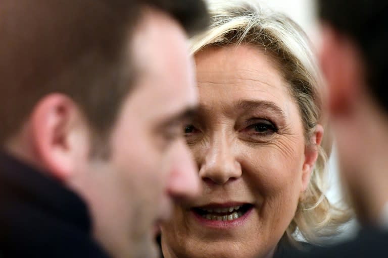 French far-right Front National (FN) party candidate for the presidential election Marine Le Pen speaks with FN vice-president Florian Philippot (L) after a press conference in Paris, on March 2, 2017