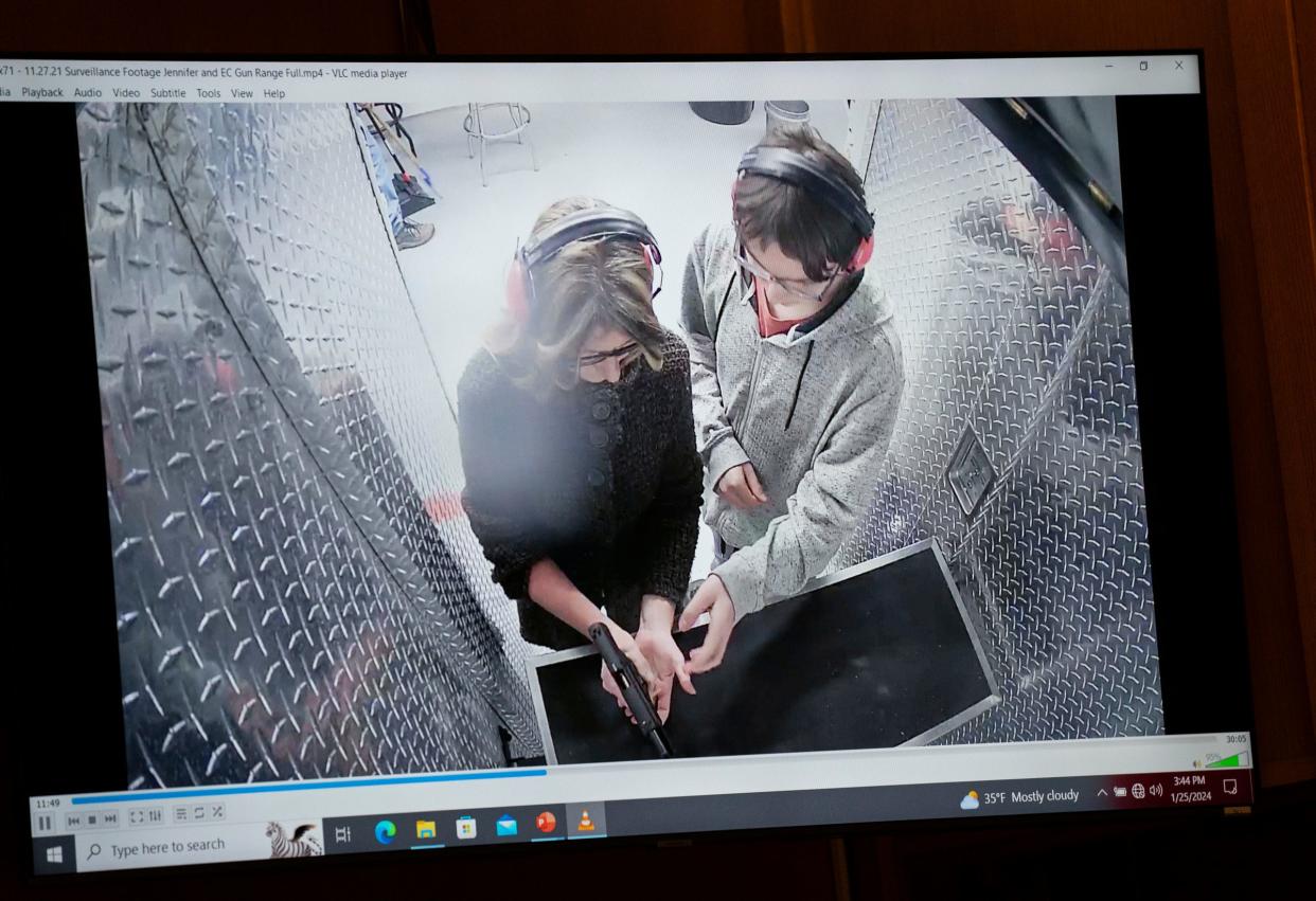 Jennifer Crumbley is shown with her son Ethan Crumbley at a gun range on Nov. 27, 2021, for target practice on a screen in the courtroom of Oakland County Judge Cheryl Matthews on Thursday, Jan. 25, 2024, to begin the trial of Jennifer Crumbley who is being tried in four counts of involuntary manslaughter. Ethan Crumbley killed four students at Oxford High School just days after this surveillance video was taken of them at the range.