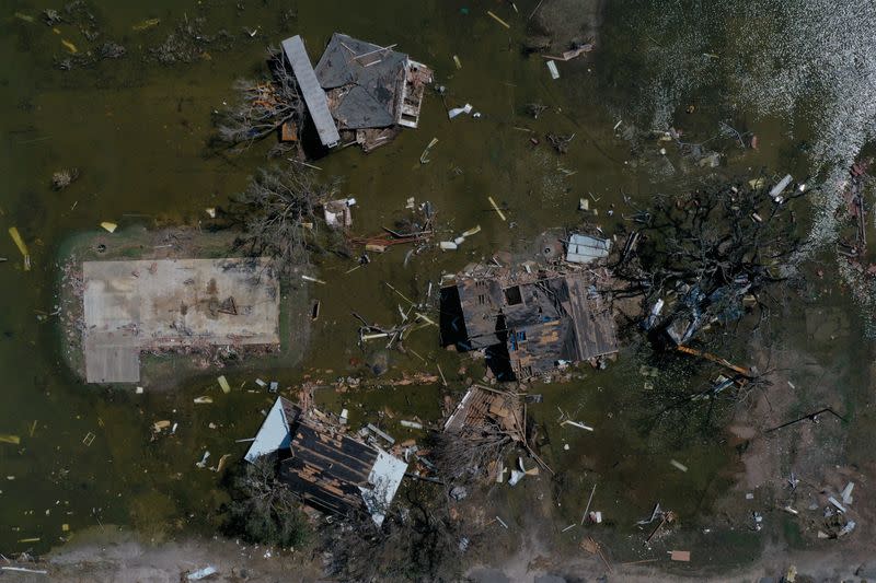 FILE PHOTO: Destroyed homes are surrounded by flood waters in aftermath of Hurricane Delta in Cameron, Louisiana