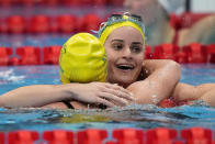 Kaylee Mckeown, of Australia, embraces teammate Emily Seebohm after winnning the gold medal in the women's 200-meter backstroke final at the 2020 Summer Olympics, Saturday, July 31, 2021, in Tokyo, Japan. (AP Photo/David Goldman)