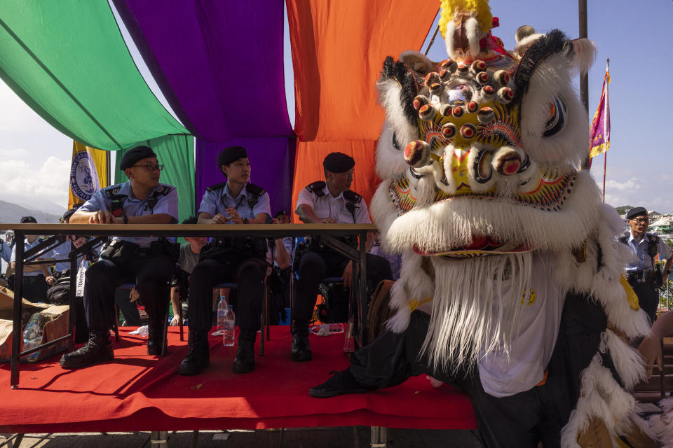 Police stand guard during the Piu Sik Parade at the Bun Festival in Cheung Chau Island in Hong Kong, Friday, May 26, 2023. (AP Photo/Louise Delmotte)