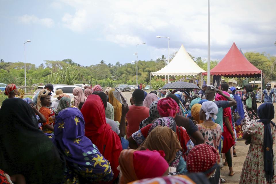 Residents queue for water in Tsoundzou, on the French Indian Ocean territory of Mayotte, Saturday, Oct. 21, 2023. The crisis is a wakeup call to the French government about the challenges and cost of managing climate change across France’s far-flung territories. (AP Photo/Gregoire Merot)