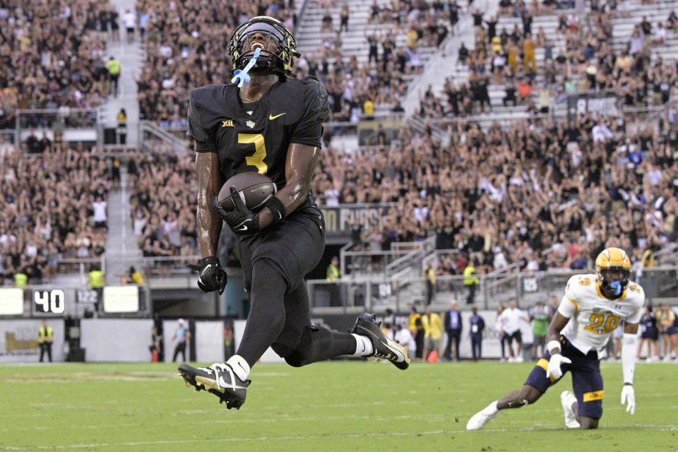 Central Florida wide receiver Xavier Townsend (3) celebrates after scoring a 9-yard touchdown after catching a pass in front of Kent State defensive back Jalani Williams (29) during the first half of an NCAA college football game, Thursday, Aug. 31, 2023, in Orlando, Fla. (AP Photo/Phelan M. Ebenhack)