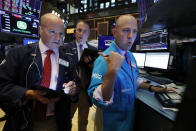 Traders Patrick Casey, left, and Jonathan Corpina, center, work with specialist Jay Woods on the floor of the New York Stock Exchange, Wednesday, Aug. 14, 2019. The Dow Jones Industrial Average sank 800 points after the bond market flashed a warning sign about a possible recession for the first time since 2007. (AP Photo/Richard Drew)