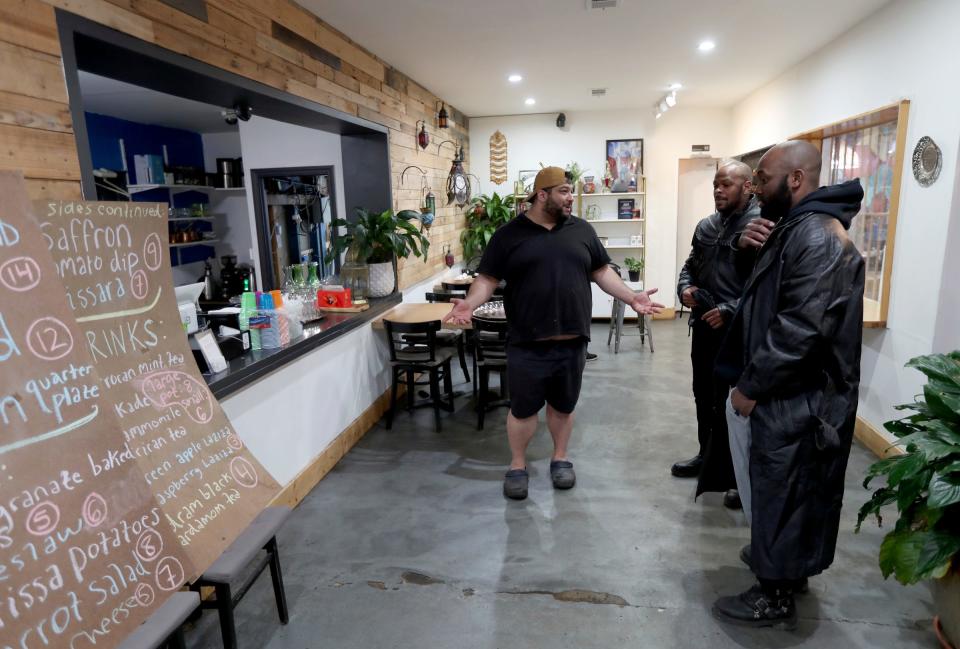 Owner and head chef Omar Anani of Saffron De Twah talks with Denzel Rainse and Andre King about the menu Saturday, April 30, 2022. The restaurant specializes in modern Moroccan food.