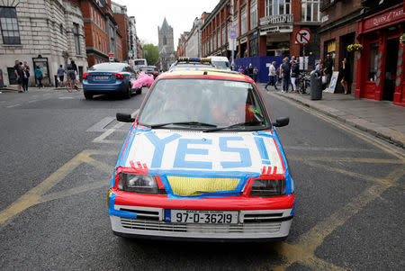 A car decorated in favour of the liberalization of Ireland's abortion laws is driven as people celebrate the result of yesterday's referendum on liberalizing abortion law, in Dublin, Ireland, May 26, 2018. REUTERS/Max Rossi