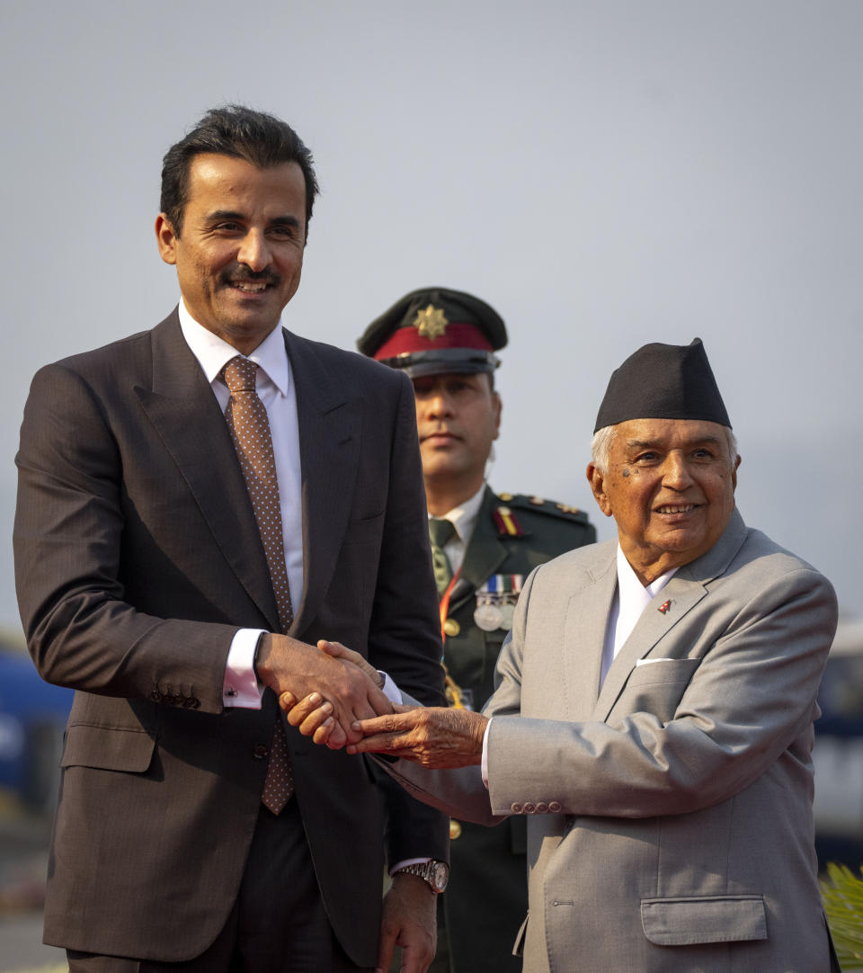 Qatar's Emir Sheikh Tamim bin Hamad Al Thani, is received by Nepal President Ram Chandra Poudel, right as he arrives at the airport in Kathmandu, Nepal, Tuesday, April 23, 2024. The emir is on a two-days visit to the Himalayan nation. (AP Photo/Niranjan Shreshta)