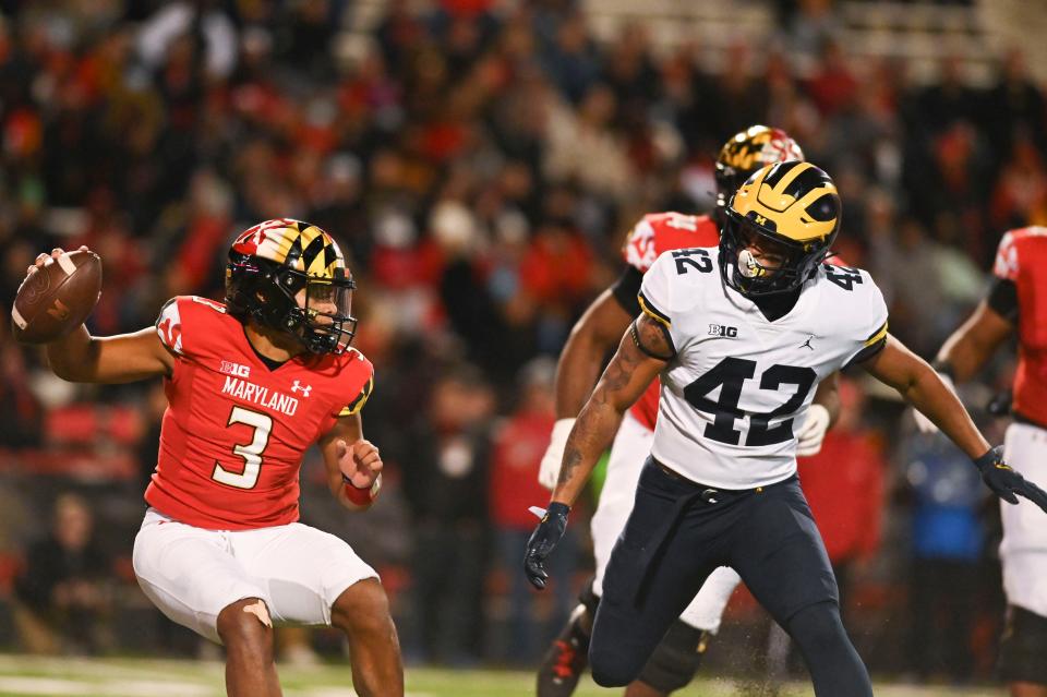 Maryland Terrapins quarterback Taulia Tagovailoa (3) cuts as Wolverines defensive back Trevor Andrews (42) defends during the second half Nov. 20, 2021 at Capital One Field at Maryland Stadium.