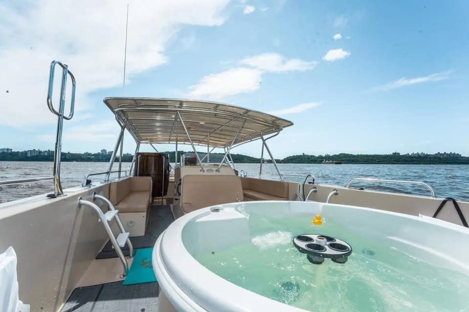 A boat with a hot tub on the Hudson River.