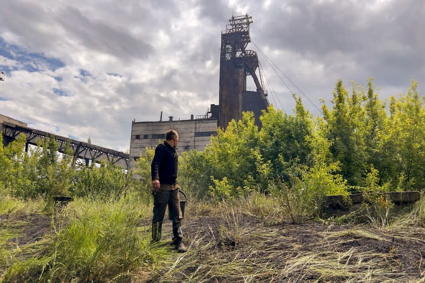 Workers move quickly to put out a fire around the St. Matrona mine after a Russian artillery attack in Toretsk, Ukraine