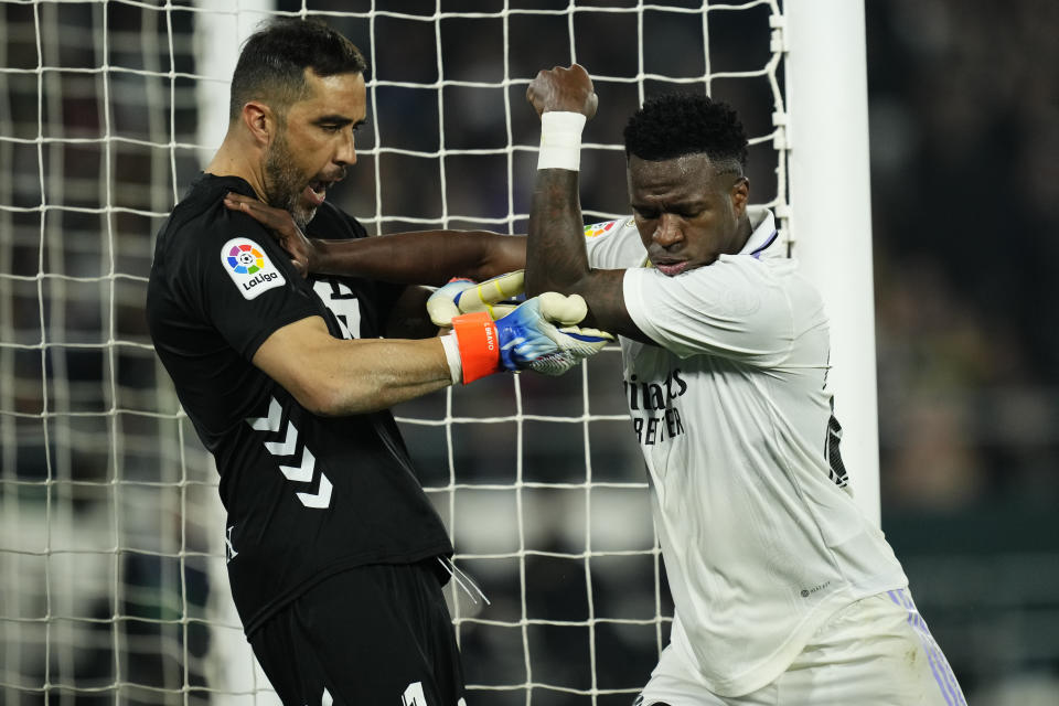 Real Madrid's Vinicius Junior, right, argues with Betis' goalkeeper Claudio Bravo during the Spanish La Liga soccer match between Real Betis and Real Madrid at the Benito Villamarin stadium in Seville, Spain, Sunday, March 5, 2023. (AP Photo/Jose Breton)