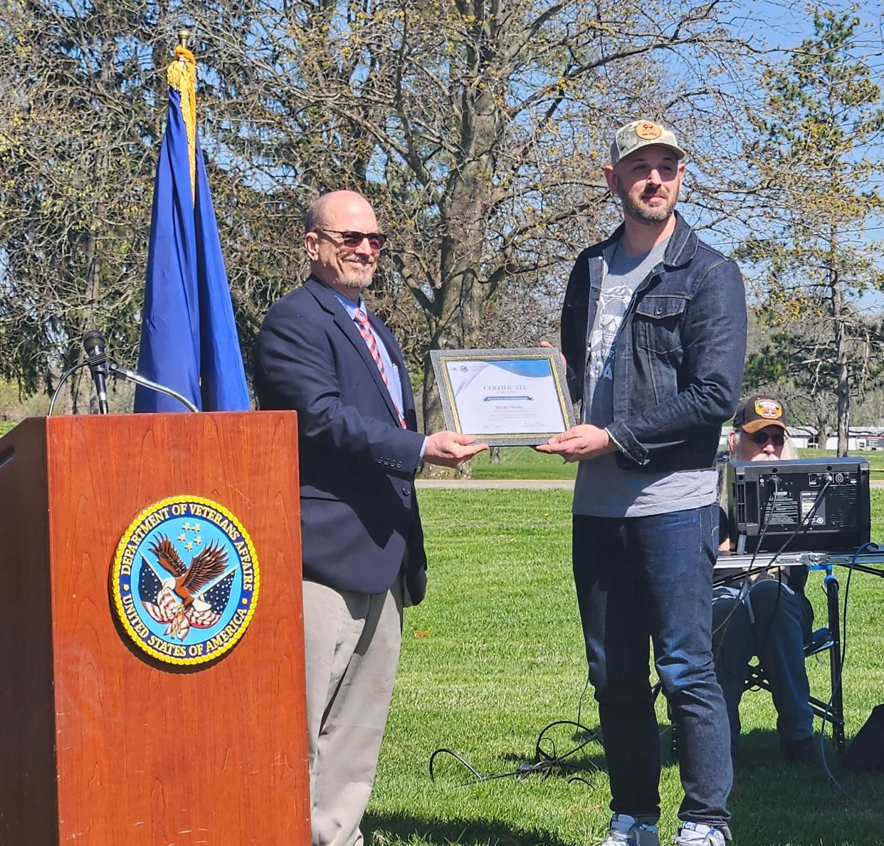 Associate Director Dr. Robert Taylor thanked Micah Shanks, President of Project Bad Apple, a community partner in this project for his hard work during the official opening of the disc gold course.
