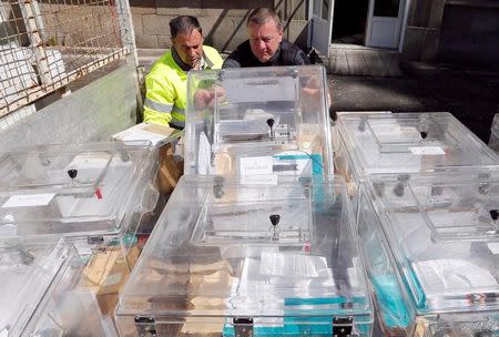 Municipal employees prepare ballot boxes on the eve of the first round of the French presidential election at a polling station in Tulle, France, April 22, 2017. REUTERS/Regis Duvignau