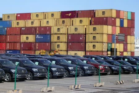 FILE PHOTO: Imported Mercedes Benz cars are seen next to containers at Tianjin Port, in northern China February 23, 2017. REUTERS/Jason Lee