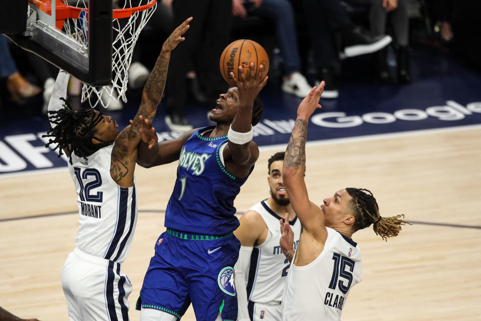 MINNEAPOLIS, MN - APRIL 29: Anthony Edwards #1 of the Minnesota Timberwolves goes up for a shot while Ja Morant #12 and Brandon Clarke #15 of the Memphis Grizzlies defend in the second quarter  during Game Six of the Western Conference First Round at Target Center on April 29, 2022 in Minneapolis, Minnesota. NOTE TO USER: User expressly acknowledges and agrees that, by downloading and or using this Photograph, user is consenting to the terms and conditions of the Getty Images License Agreement. (Photo by David Berding/Getty Images)