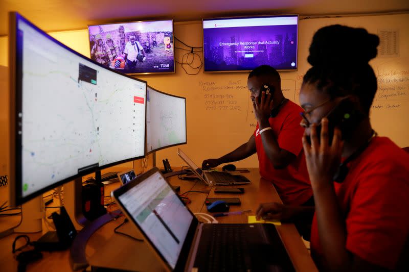 Dispatchers for the Rescue.org free ambulance service look at computer screens during the coronavirus night curfew in Nairobi