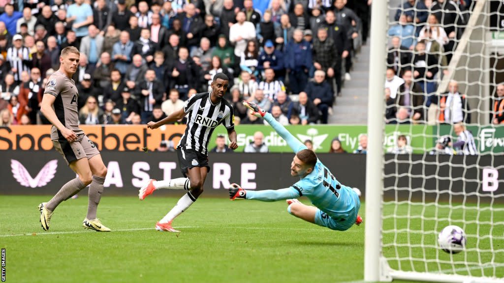 Newcastle striker Alexander Isak fires the ball beyond Tottenham goalkeeper Guglielmo Vicario
