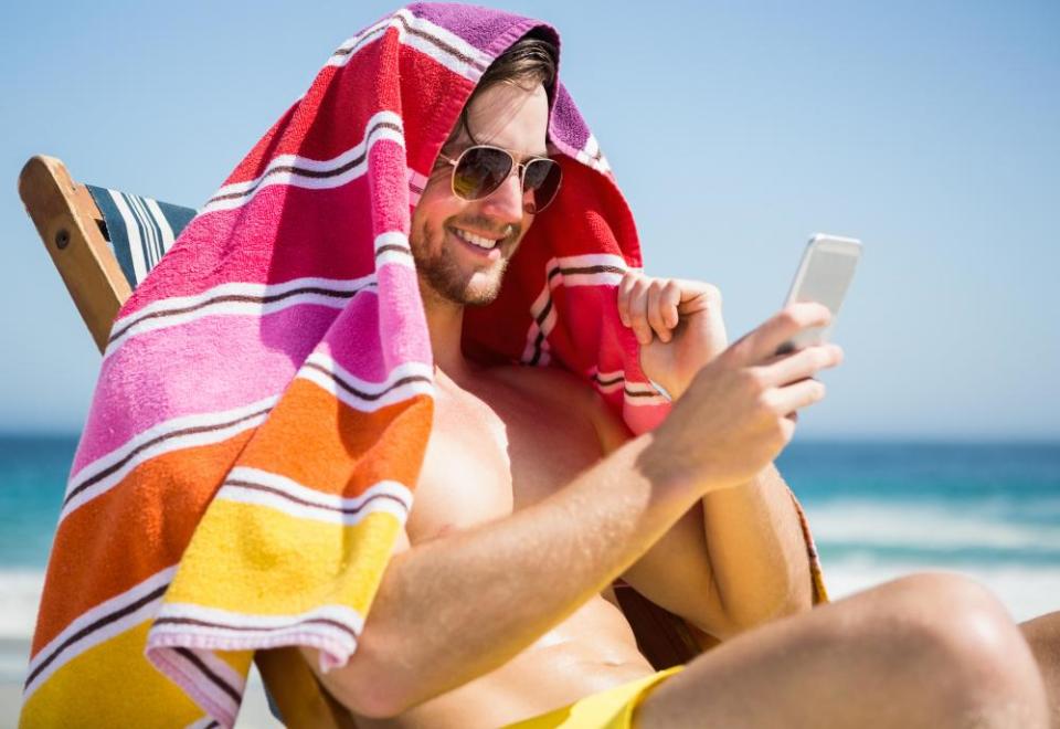 Man relaxing and using smartphone.