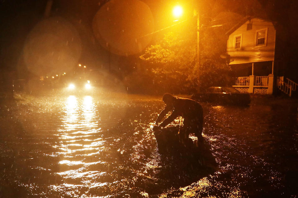 Michael Nelson floats in a boat made from a metal tub and fishing floats after the Neuse River went over its banks and flooded his street in New Bern on Thursday.