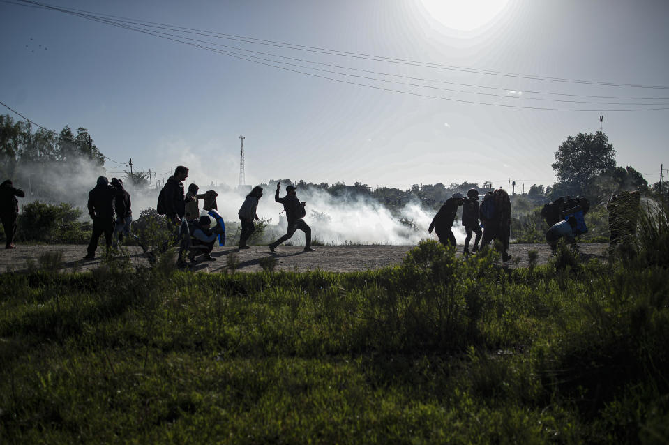 People fight back as police carry out evictions at their squatters camp in Guernica, Buenos Aires province, Argentina, Thursday, Oct. 29, 2020. A court ordered the eviction of families who have been squatting at the camp since July, but the families say they have nowhere to go amid the COVID-19 pandemic. (AP Photo/Natacha Pisarenko)