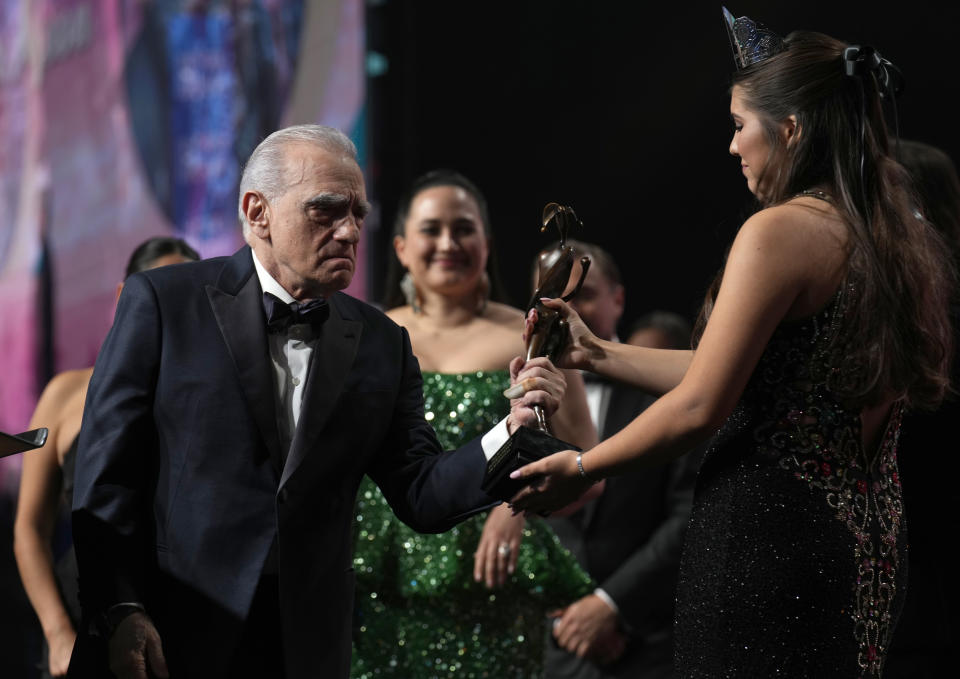 Lawren "Lulu" Michele Goodfox, right, presents the vanguard award to Martin Scorsese for "Killers of the Flower Moon" at the 35th annual Palm Springs International Film Festival Awards Gala on Thursday, Jan. 4, 2024, in Palm Springs, Calif. (AP Photo/Chris Pizzello)