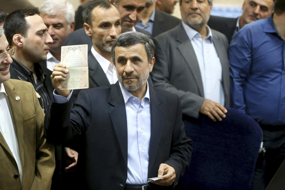 Former Iranian President Mahmoud Ahmadinejad shows his identification during registering his candidacy for the upcoming presidential elections at the Interior Ministry in Tehran, Iran, Wednesday, April 12, 2017. Ahmadinejad on Wednesday unexpectedly filed to run in the country's May presidential election, contradicting a recommendation from the supreme leader to stay out of the race. (AP Photo/Ebrahim Noroozi)