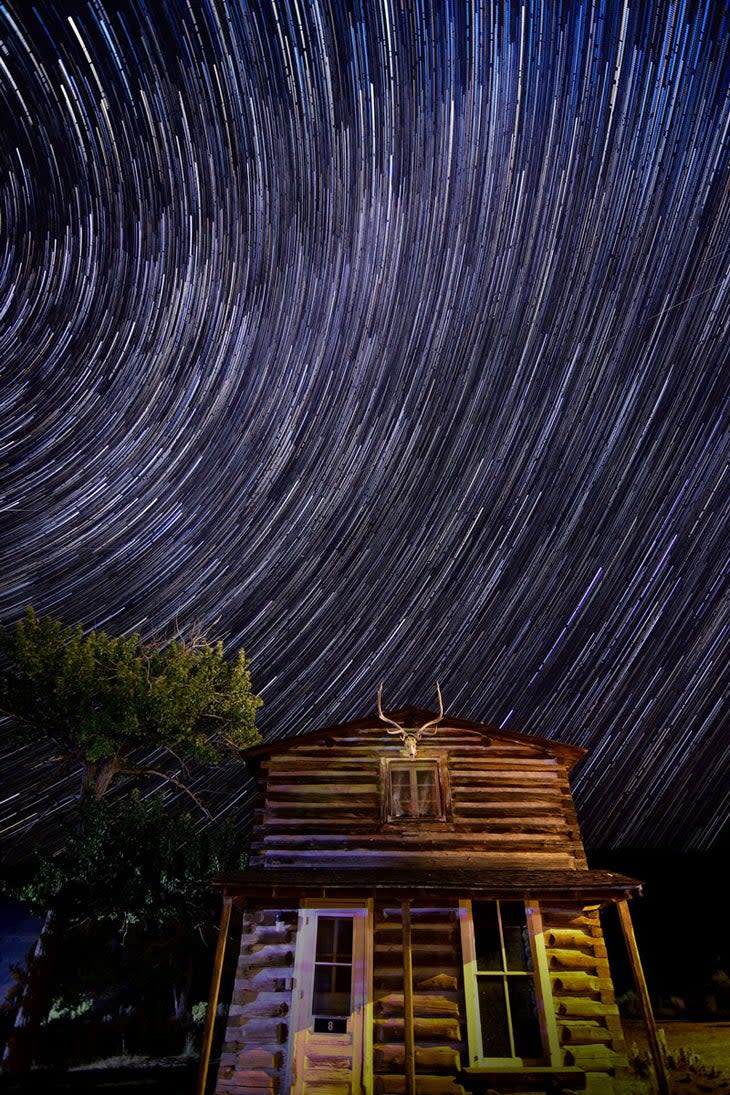 Star trails over the postman's cabin at Historic Fort Yellowstone in Yellowstone National Park