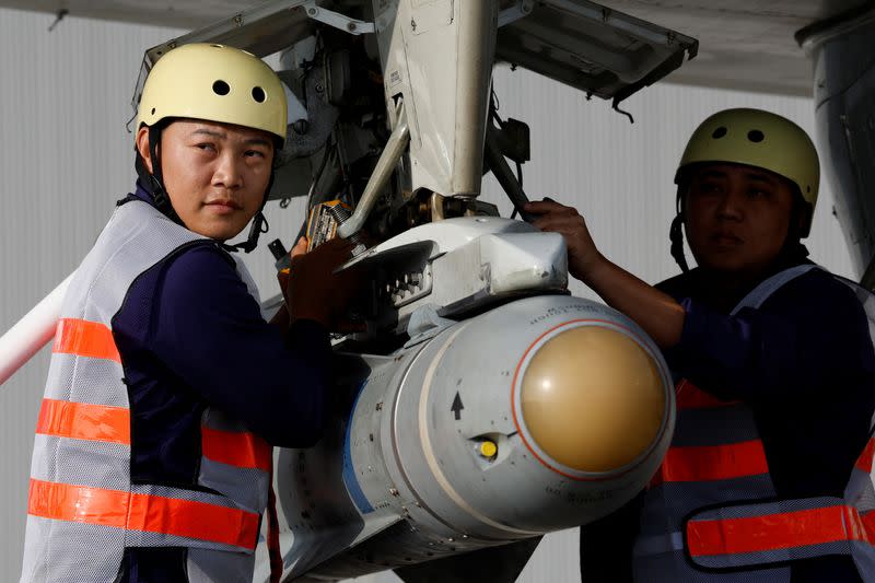 Members of the Taiwan Air Force attach an AGM-65 Maverick missile to a P-3C Orion aircraft during a demonstration for the media at the Pingtung air base in Pingtung