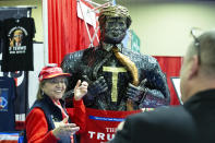 A supporter of President Trump poses for a photo next to a figure during Conservative Political Action Conference, CPAC 2020, at the National Harbor, in Oxon Hill, Md., Thursday, Feb. 27, 2020. (AP Photo/Jose Luis Magana)